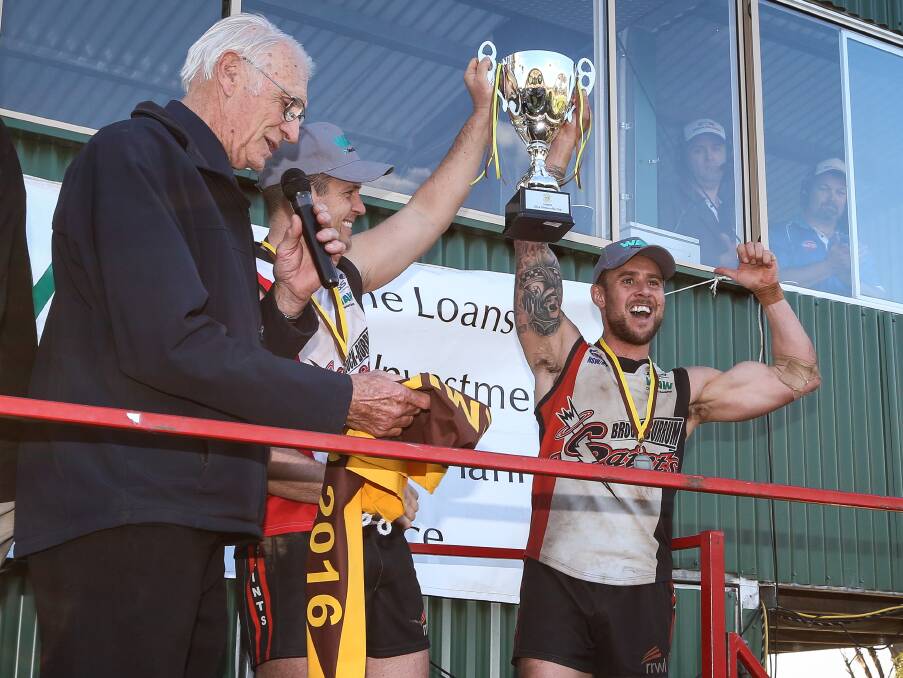 SILVERWARE: Jarrod Hillary and Luke Brauer lift the premiership cup after Saturday's 33-point win.