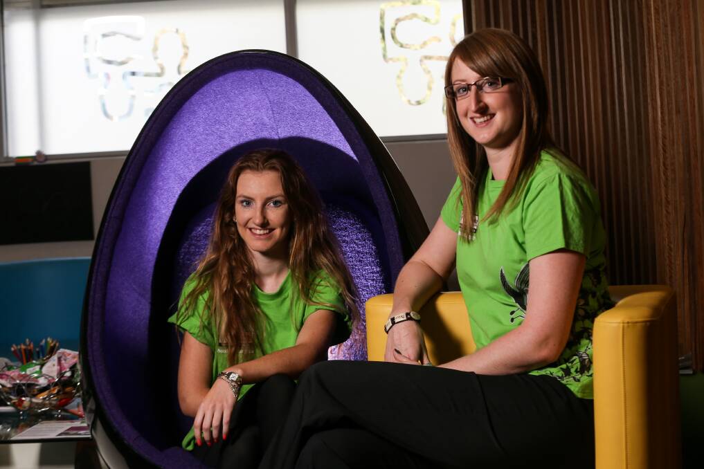 EGG-CELLENT: Youth reference group members Olivia Carmody and Sarah Negrin with one of the egg chairs that have proven so popular.