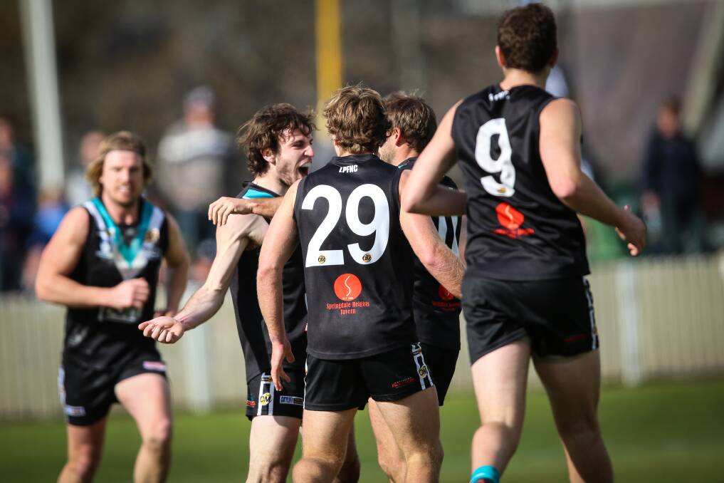 Lavington's Chris Annett is congratulated after kicking a sensational running goal in the first quarter of the Panthers' 66-point win over Yarrawonga. Picture: JAMES WILTSHIRE