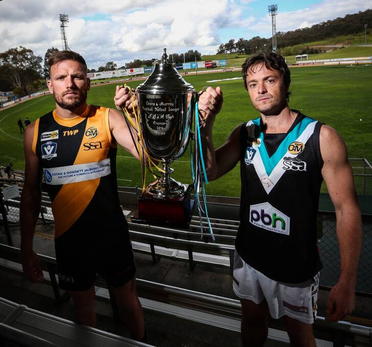 PLAYING FOR KEEPS: Albury star Dean Polo and Lavington captain Kade Stevens with the Ovens and Murray premiership cup on Friday. Picture: JAMES WILTSHIRE