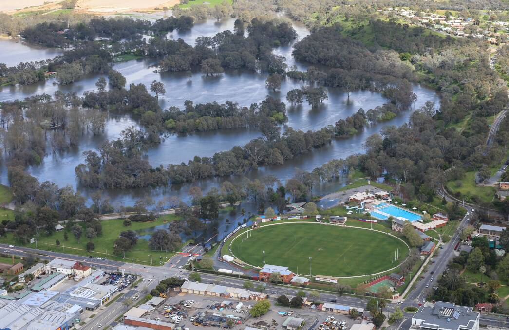 RISING FAST: Flood waters closed in on the Albury Sportsground and pool precinct in October. Helifly took Border Mail photographer James Wiltshire to see the extent of flooding from the air.