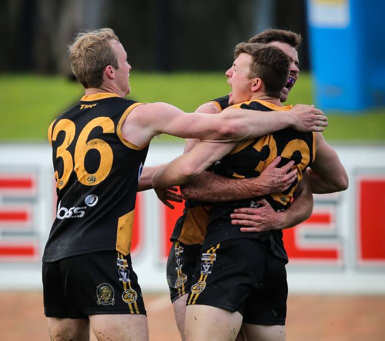 SEALER: Powell is mobbed after putting the Tigers 27 points clear in the third term. Pictures: JAMES WILTSHIRE