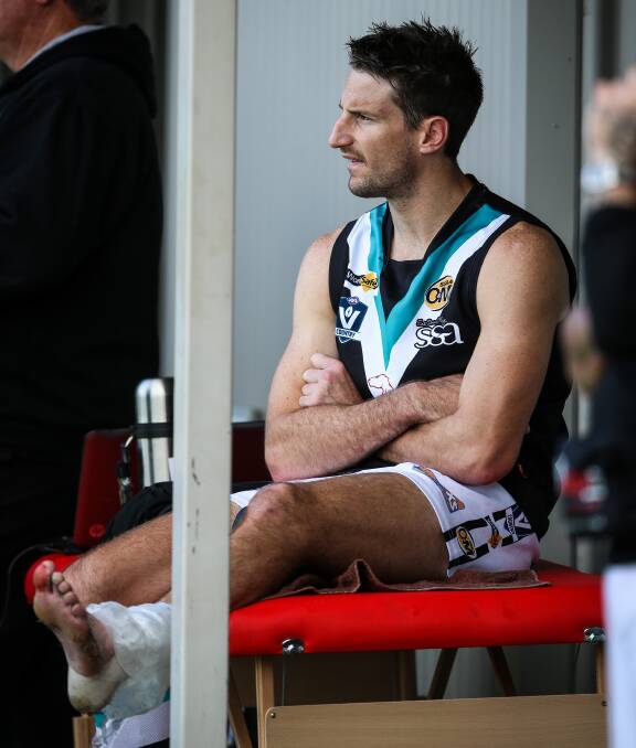 Brant Dickson ices his ankle after badly hurting it against Yarrawonga in round eight.