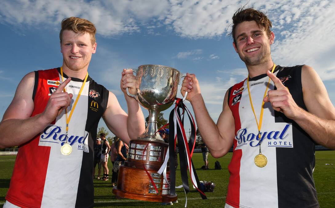 SAINTLY SIGNINGS: Jordan Wolff and Barnawartha coach Mitch Exton celebrate their 2015 grand final victory with Benalla. Picture: MARK JESSER