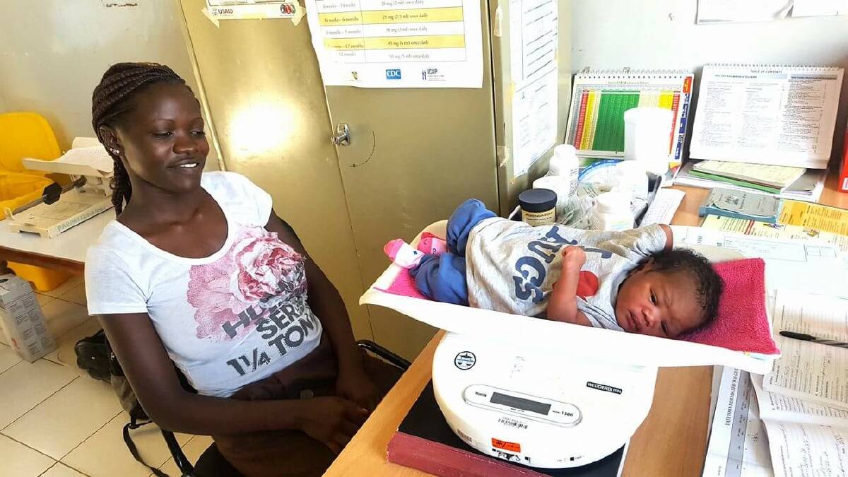 Nineteen-year-old Kenyan woman Celine with her bouncing baby girl Sarah, named in honour of Wodonga nurse Sarah Dechert who assisted Celine during her labour.