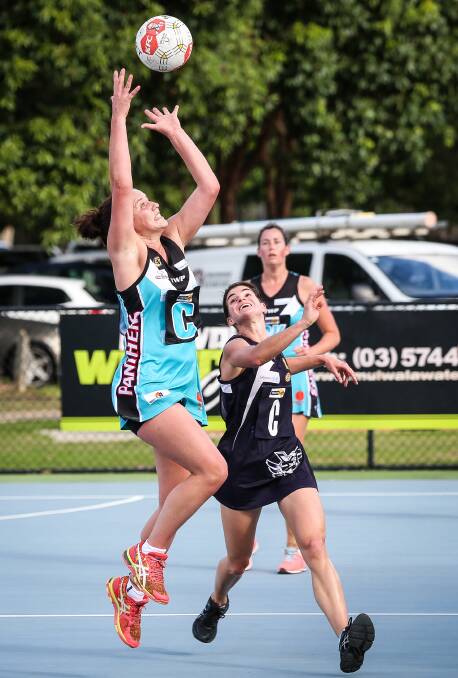 CENTRE STAGE: Lavington star Emily Browne leaps for the ball as Yarrawonga counterpart Laura Bourke applies pressure in the battle of the undefeated teams on Saturday. 