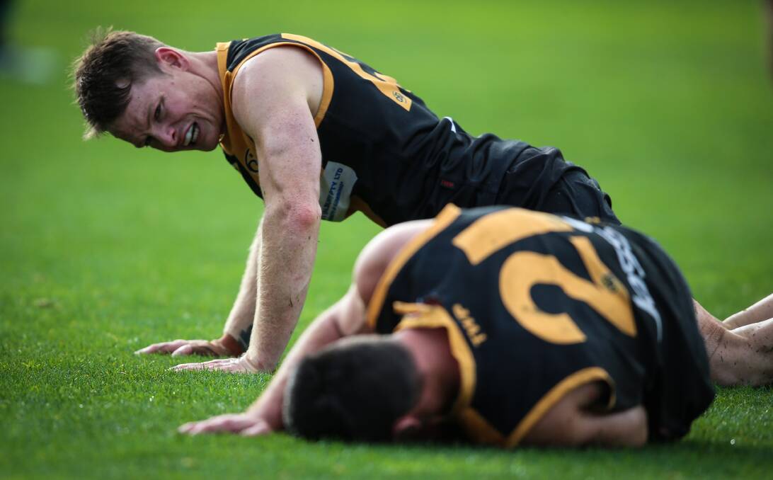 MACKIE WHACK: Albury's Luke Daly checks on teammate Joel Mackie after the pair collided heavily in the third quarter. Picture: JAMES WILTSHIRE