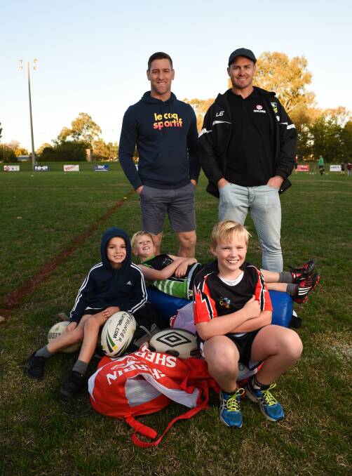 LEARNING ABOUT LEAGUE: Former stars Brent Tate and Matt Cooper meet Oliver Gabriel, 6, Fletcher Dennis, 7, and Max Cunningham, 10, at the Albury clinic on Monday, part of the Road to Origin regional tour. Picture: MARK JESSER
