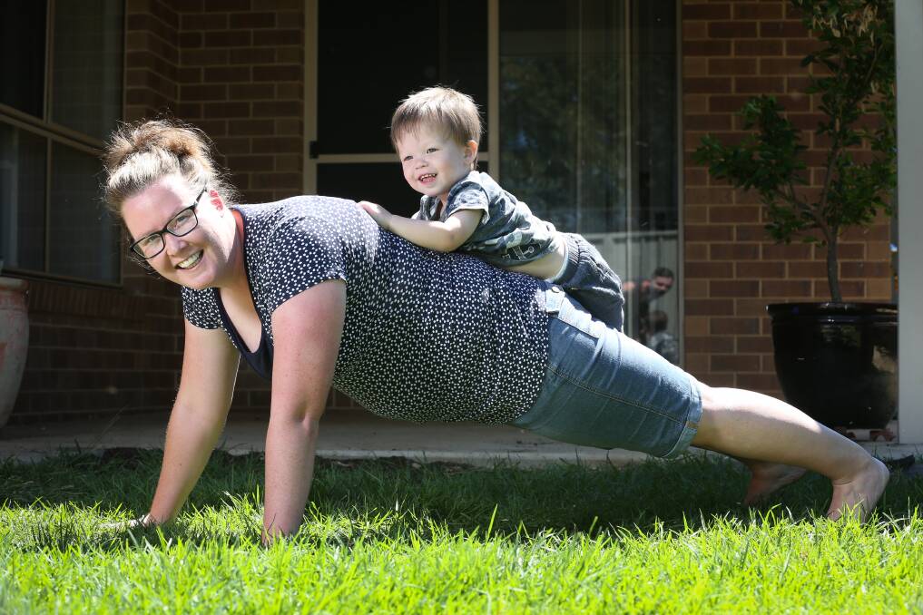 HAPPY TO HELP OUT: Thurgoona's Jayde Butler trains for The March Charge fundraiser of the Cancer Council with the assistance of her son Oliver Pitt, 21 months. Oliver is now healthy after testicular cancer last year. Picture: KYLIE ESLER