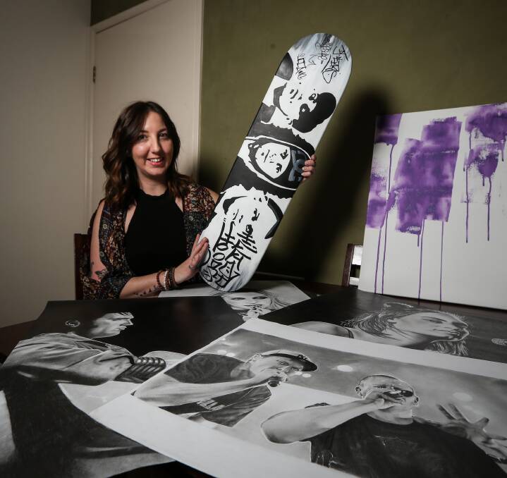 CHARITABLE ART: Border artist Marni Korneluk wants to raise money for Seeing Eye Dogs Australia by selling a skateboard that displays her painting of Hilltop Hoods and includes the group's signatures. Pictures: JAMES WILTSHIRE