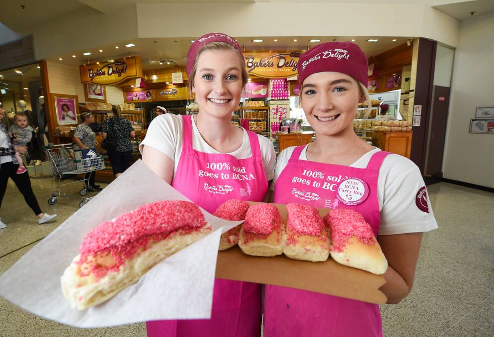 BUNDLES OF BUNS: Nat Taffe and Bonnie West, of Bakers Delight Wodonga, hope to sell lots of pink buns during May, with all proceeds from the annual campaign going to Breast Cancer Network Australia. Picture: MARK JESSER