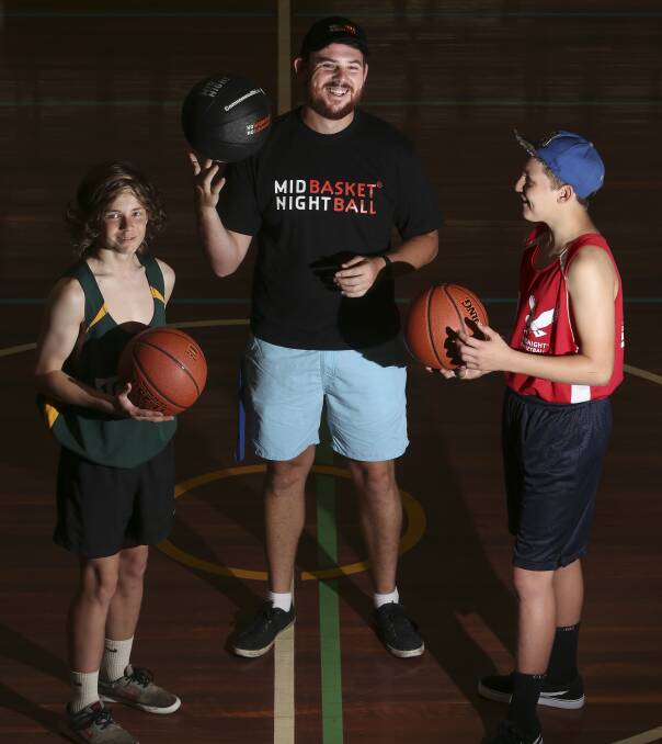 GAMES AFTER DARK: Cameron Regulski, youth worker Taylor Hampton and Jordon Grant catch up during the Midnight Basketball Wodonga tournament last year.