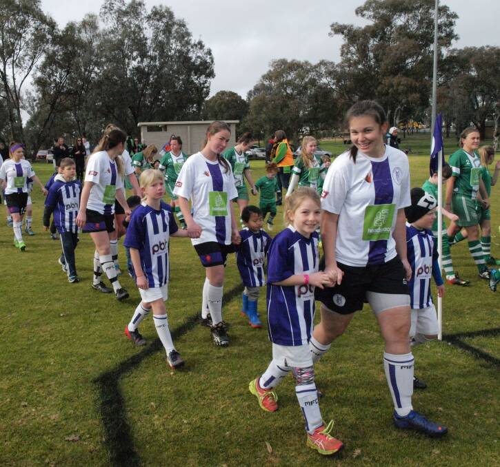 SPECIAL EVENT: Melrose youngster Lucie Hayes and senior women's player Ashlea Thurnam parade with Hamish McLennan and the other players. 