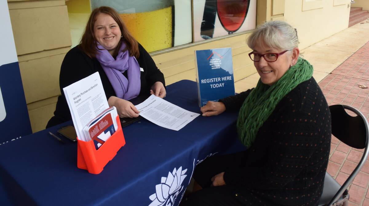 ANSWERING QUESTIONS: NSW Fair Trading's Kelly Bird speaks to resident Janelle Quilter at the loose-fill asbestos program information stand in Culcairn on Thursday.