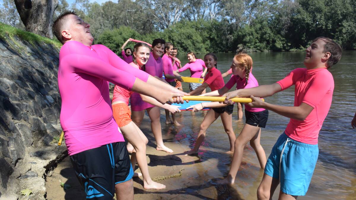 BE FLEXIBLE: Catholic College Wodonga students learn everyday objects can help in a water rescue at Life Saving Victoria's Open Water Learning Experience on Tuesday.
