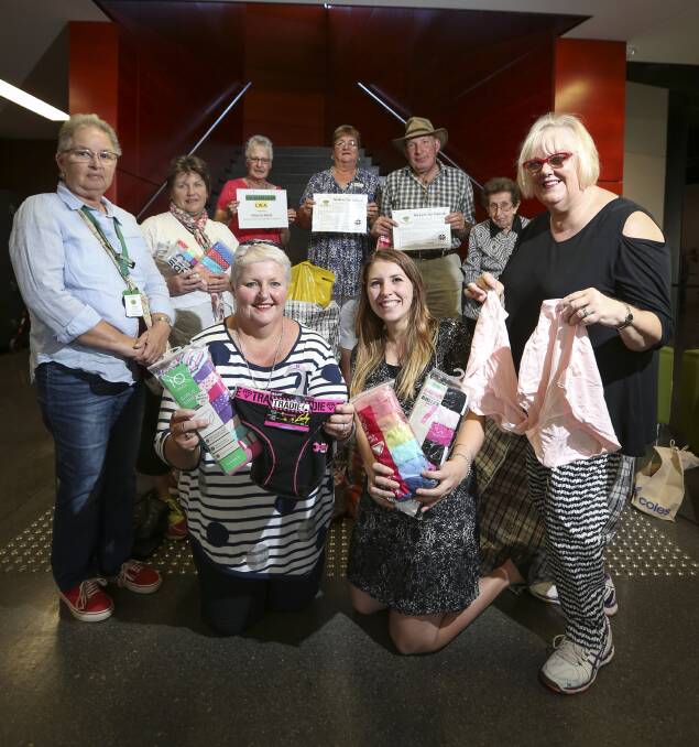 A TWIST OF KNICKERS: Baulkamaugh CWA members, led by Bridget Goulding (kneeling left), hand over their underwear donation to Mount Beauty Uniting Church's Knickers for Nairobi project. Picture: JAMES WILTSHIRE