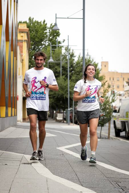 DAY 81: Bounding Plains to Share's Jackson Bursill and Cassie Cohen run along Kiewa Street during their Albury visit on Wednesday. Picture: JAMES WILTSHIRE