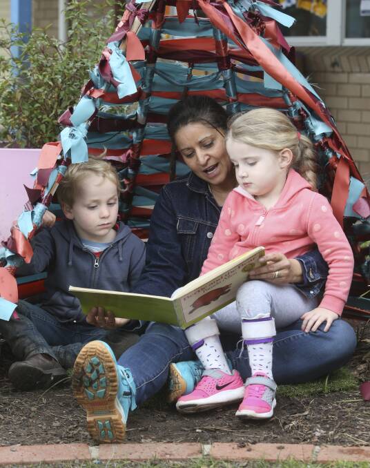 EXCELLENT RATING: Lachlan Morison and Harper Baird, both 4, listen as educator Lany Wesley reads them a story at Albury Preschool this week. Picture: ELENOR TEDENBORG