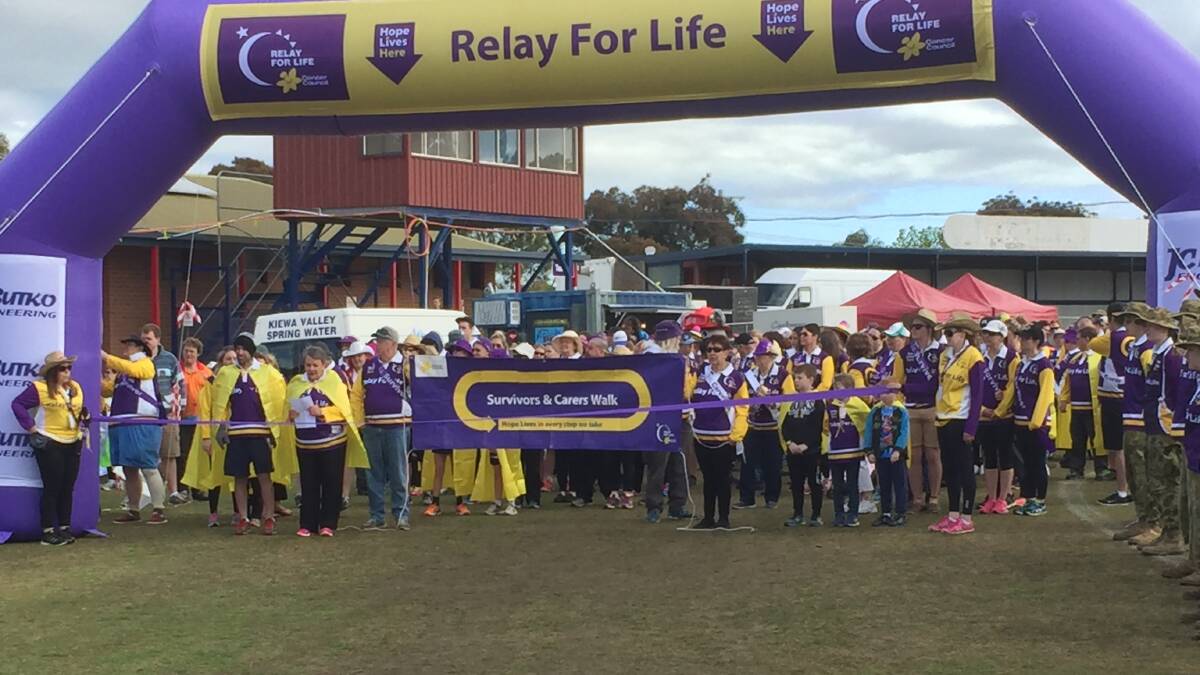 HONOURED GUESTS: Survivors of cancer and carers prepare to walk the first lap at Birallee Park, Wodonga as the 2016 Border Relay for Life begins on Saturday morning.