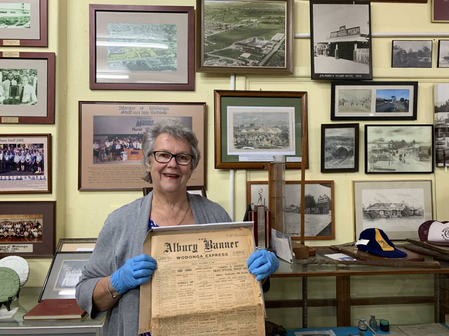 PAPERS PRESERVED: Wodonga Historical Society's Uta Wiltshire holds a rare hard copy of Albury Banner and Wodonga Express, soon to be more accessible online.