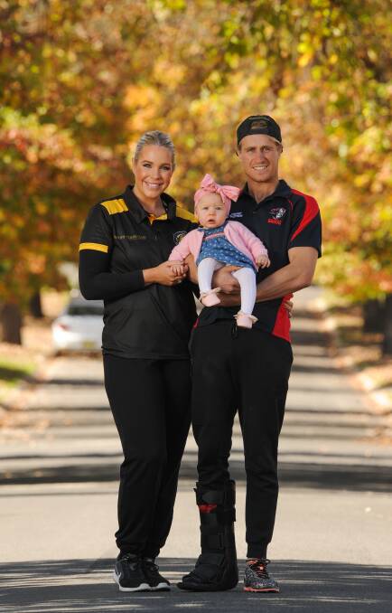 FAMILY RIVALRY: An injured Steve Jolliffe, with daughter Ivy, eight months, won't compete against partner Olivia Aughton at the Dance for Cancer. Picture: MARK JESSER