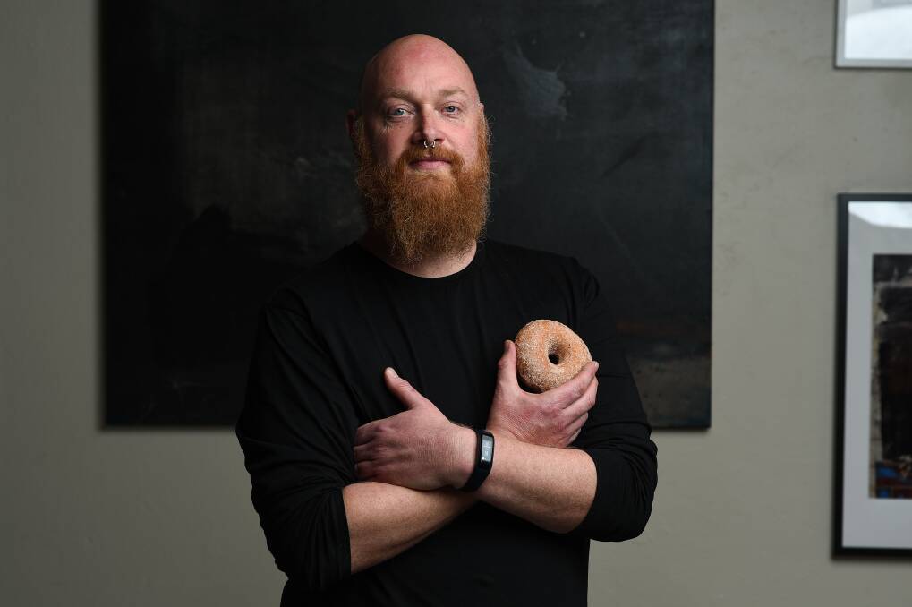 DELICIOUS DEMAND: Ashlee Laing, owner/operator of Teddy's Joint, Tallangatta, creates doughnuts named after various celebrities. "We've had the Vivien Leigh, Bobby Brown and Vladimir Nabokov," he says. Picture: MARK JESSER