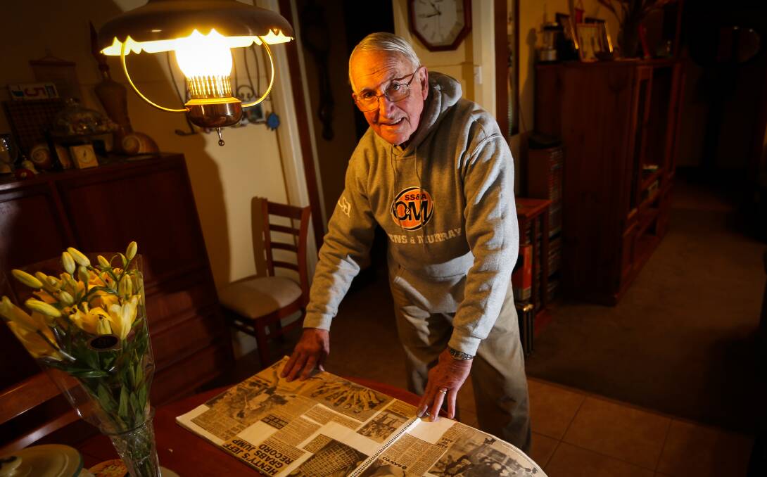 TREASURED MEMORIES: Longtime coach Les O'Brien looks over his scrapbooks in his North Albury home. Picture: JAMES WILTSHIRE