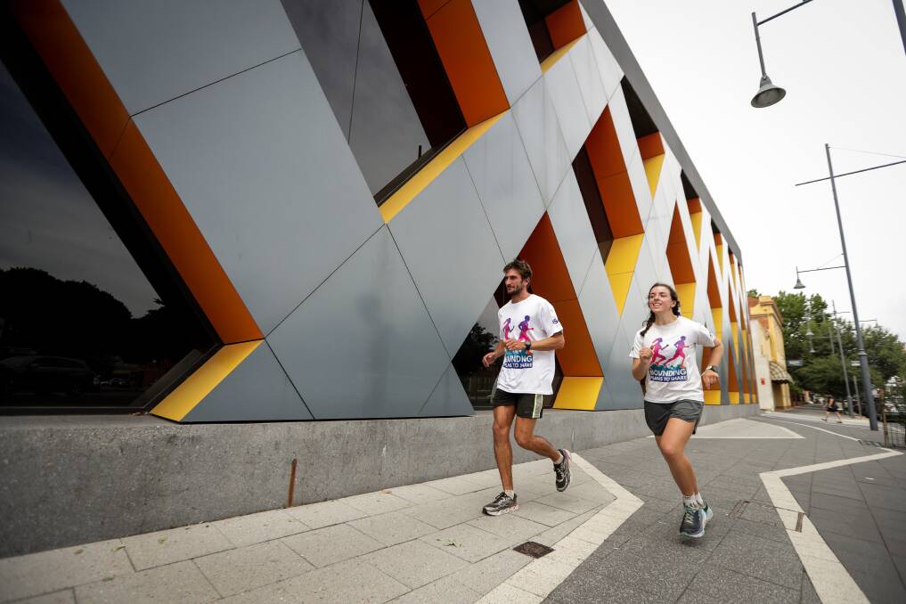 CELEBRATING COMMUNITY: Canberra's Jackson Bursill and Cassie Cohen are running about 45km a day for 100 days. Picture: JAMES WILTSHIRE