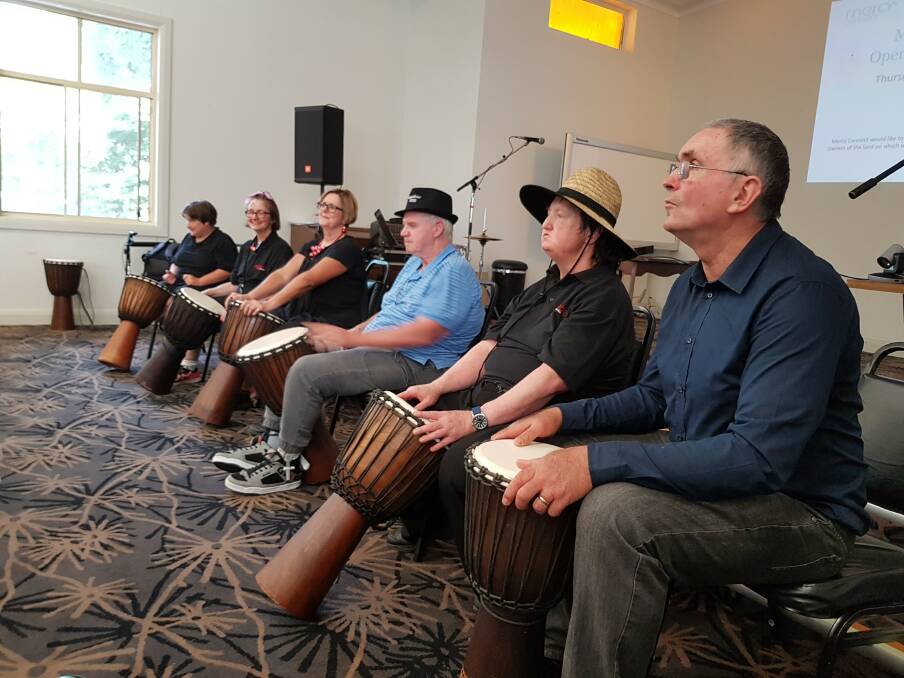 DRUMMING DEMONSTRATION: Mercy Connect participants and staff Erina, Coral, Marianne, Wayne, Mark and Anthony perform to guests at last month's open day.