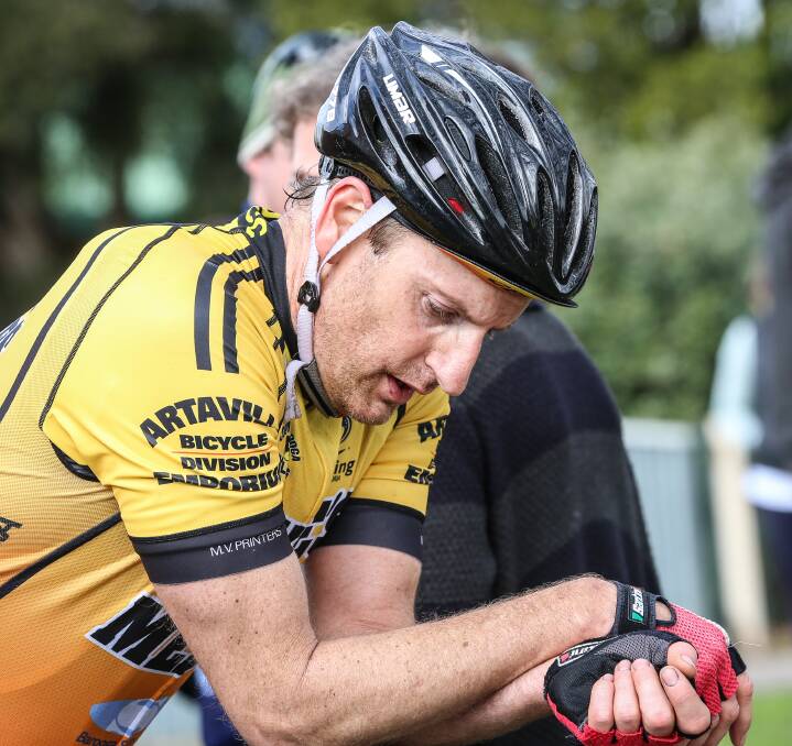 ALL DONE: Tony Crawford reflects on his accomplishment, and recovers, after the Cobram-Barooga rider led home nearly 120 riders to take out the 135km Wagga to Albury road race in its 30th year. Pictures: JAMES WILTSHIRE