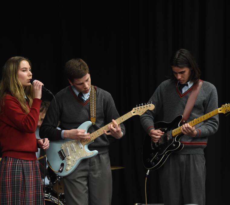 OUT OF THIS WORLD: Albury High School year 11 students Miranda Finck, 16, Charlie O'Shea, 17, and Josh Edgar, 16, from The Space Boys deliver their song.
