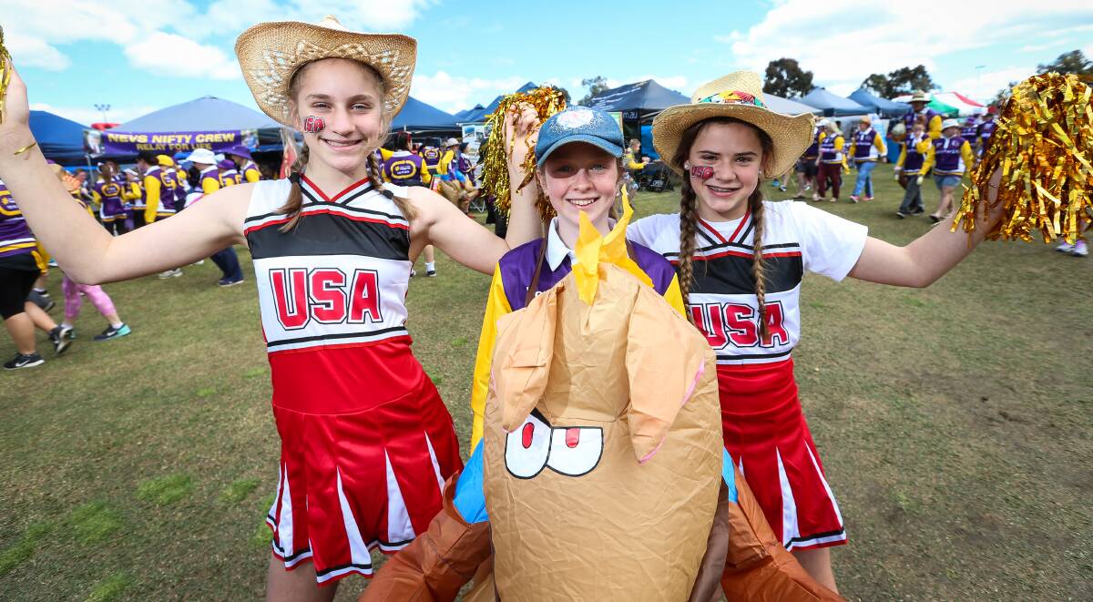 TAKING TO THE TRACK: Cheerleaders and jockeys all have their place in the Relay for Life, as shown by Victory Lutheran College team members Olivia Tully, 12, Lauren Coyle, 13, and Breeanna Bowey, 12. Pictures: JAMES WILTSHIRE