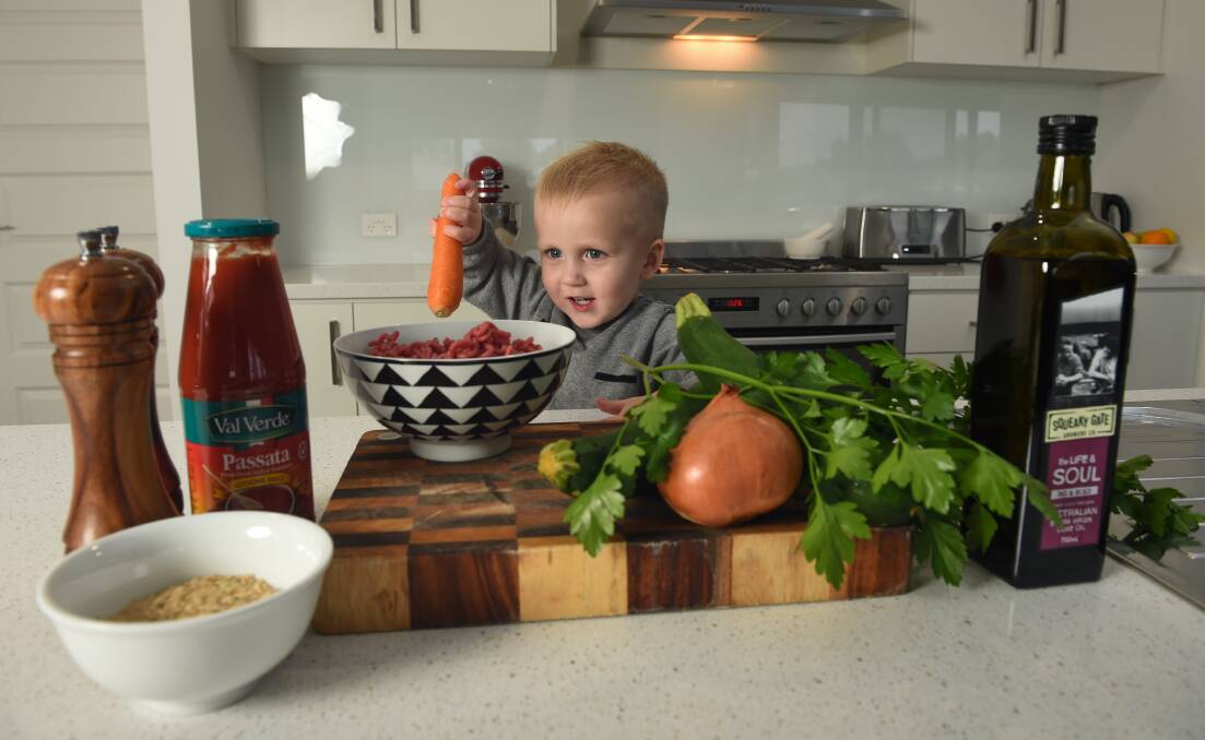 HELPING HAND: John Couston, 2,  loves to join his mum Rebekah in the kitchen.