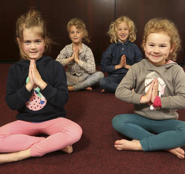 WILLING PARTICIPANTS: Mackenzie Rose, 5, Elka Ault-Connell, 6, Eva Ault-Connell, 8, and Amelia Datsun, 4, practise their techniques during the Yoga 4 Kids session at  Albury Library Museum on Tuesday. Pictures: ELENOR TEDENBORG