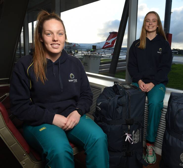 FLYING START: Brooke Dickie, 18, and Bridget Johnston, 17, wait at Albury Airport for the first stage of their overseas trip. Picture: MARK JESSER