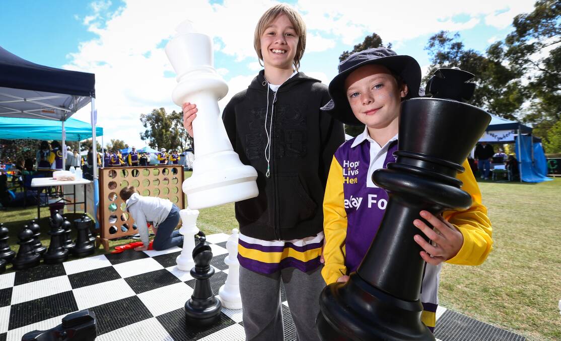 PASSING THE TIME: Blake Tanner, 13, and Hunter Ryan, 10, take the opportunity to play some oversized chess during the day. A range of activities lined the course.