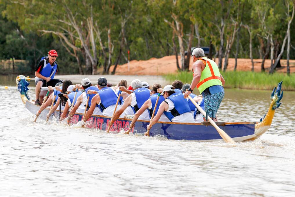 TEAMWORK: Paddlers surge for the line. More images from the Brave Hearts Dragon Boat Regatta at bordermail.com.au. Pictures: SIMON BAYLISS