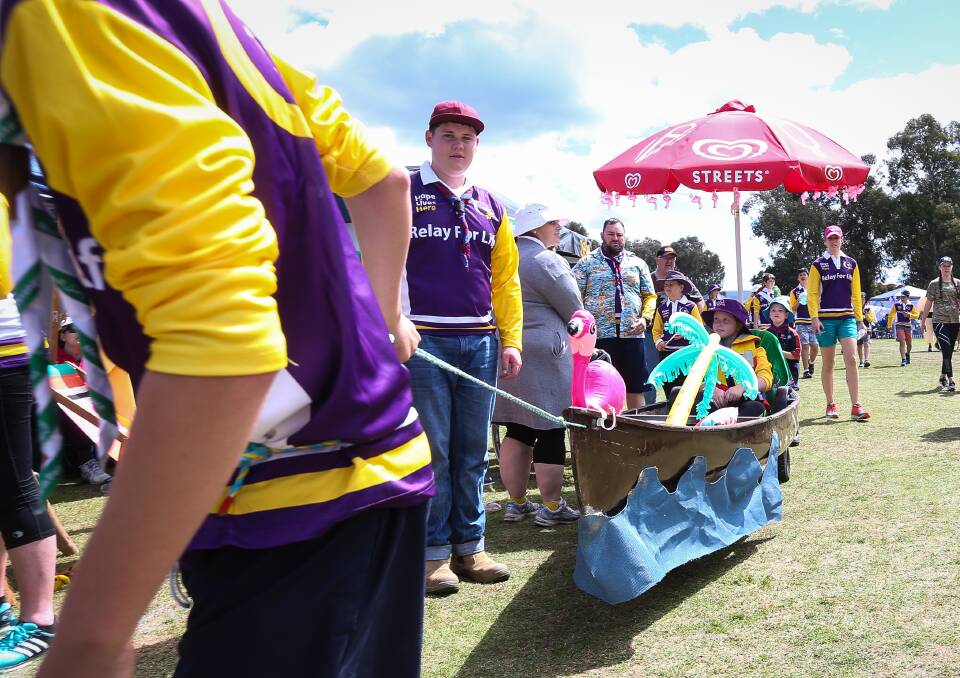 ANOTHER FORM OF TRANSPORT: Georgia Deegan, 11, enjoys a ride around the oval in a decorated canoe, courtesy of the Third Wodonga Scout Group.