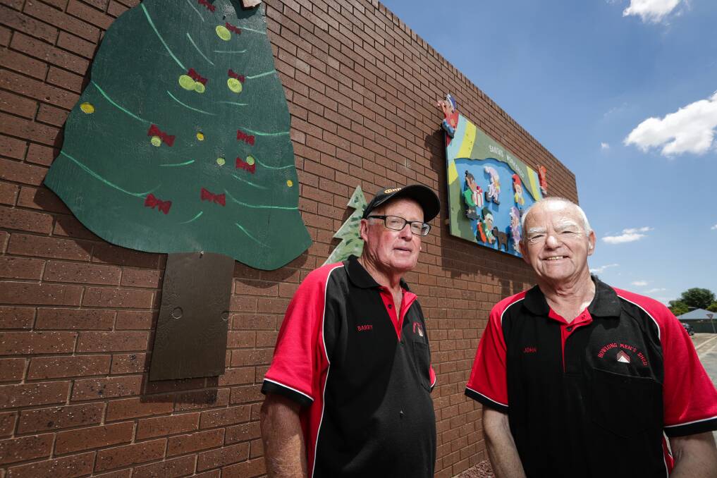 HAPPY TO HELP: Howlong Men's Shed members Barry Cross and John Mailes with some of this year's decorations. Picture: JAMES WILTSHIRE