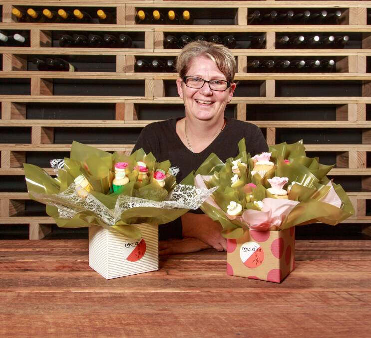 CAKE OR FLOWERS: Kath Stone, of Reclaim Winebar & Cafe, displays two of her cupcake bouquets. She created the concept in Western Australia and will use them to complement her new Myrtleford business. Picture: SIMON BAYLISS