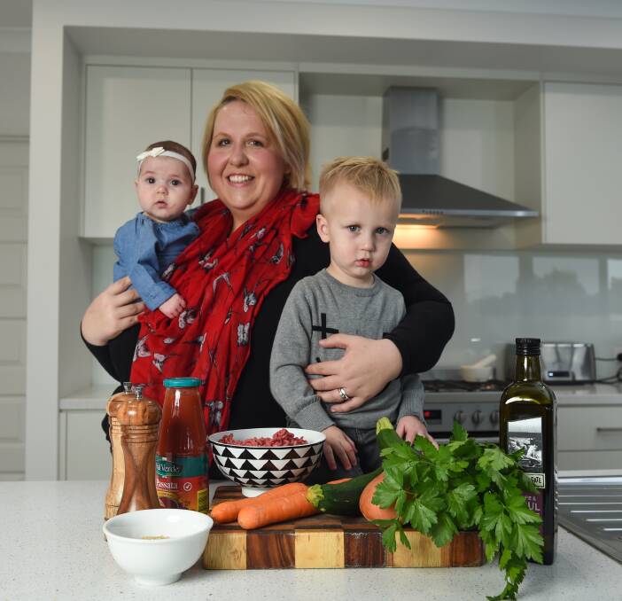 ALL TOGETHER: Thurgoona's Rebekah Couston tailors her cooking around the needs of her family, including Clara, four months, and John, 2. "I need recipes that are not only easy but nutritious," she says. Picture: MARK JESSER