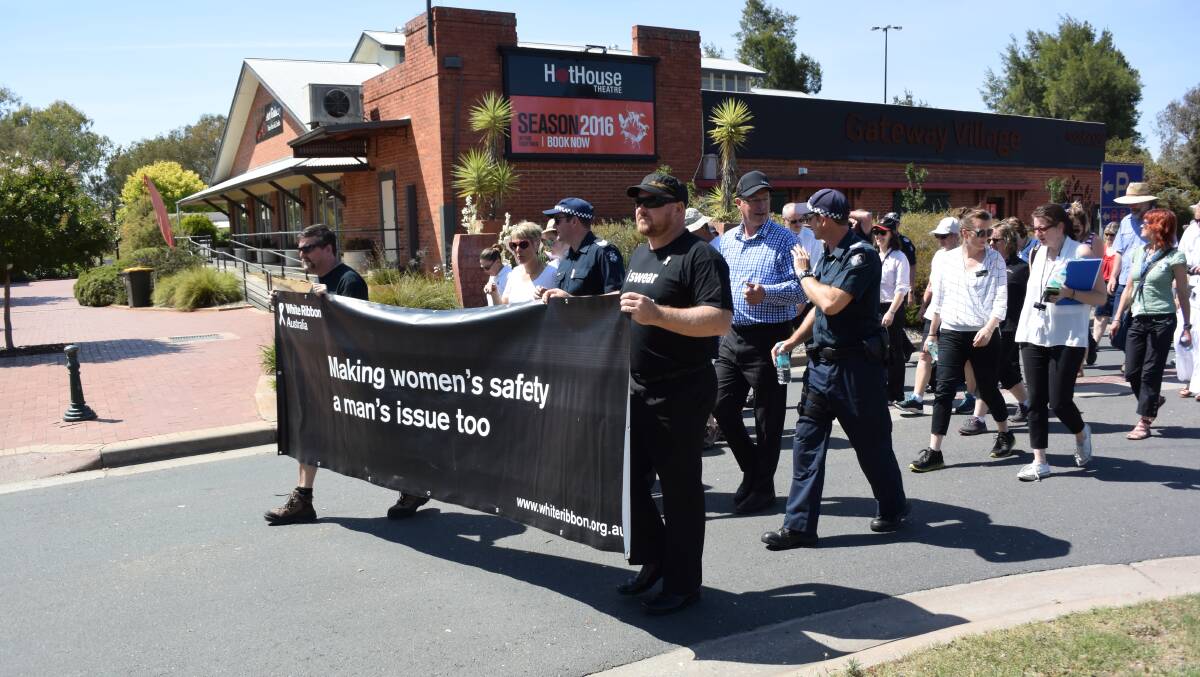 MAKING A STATEMENT: Marchers in Wodonga take part in Wednesday's White Ribbon Day event on Lincoln Causeway.
