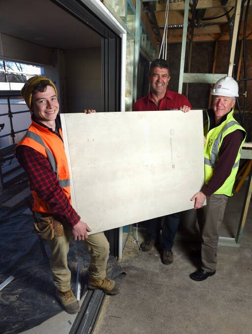 SAFETY FIRST: Apprentice Jake Eisenhauer, Modem Construction Group director Graeme Chugg and SafeWork NSW's Craig Przibilla work together. Picture: MARK JESSER