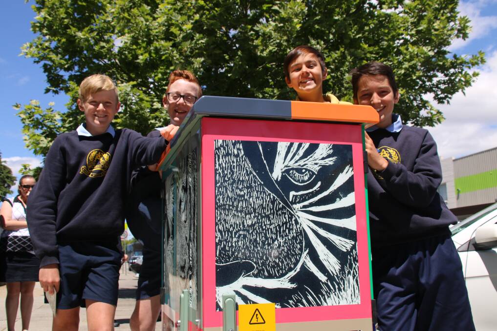 STRIKING RESULTS: Albury Public School students unveil the artwork on one of their two National Broadband Network boxes in the central business district.