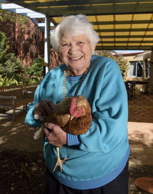 NOT FLYING THE COOP: Orsolana (Lina) Tymczuk likes to spend time with her five chickens, which recently joined her at Mercy Place Albury. Picture: SIMON BAYLISS