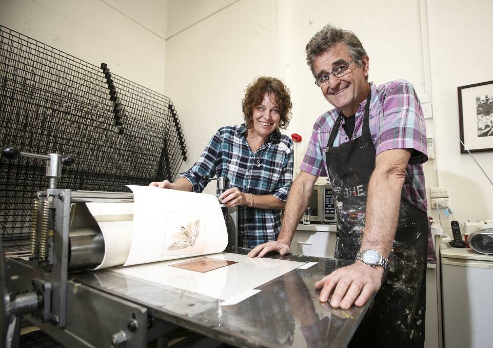 LEARNING NEW SKILLS: Emerging artist Milinda Hamilton, of Tangambalanga, tests her Bogong moth etching with the help of master printer Basil Hall during the two-day program at Creators Artspace. Picture: JAMES WILTSHIRE