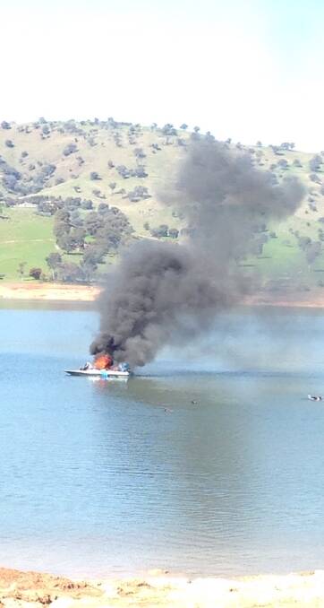 WELL ALIGHT: Flames quickly spread after an explosion aboard a boat at Lake Hume on Saturday. Nobody was hurt, but the boat was destroyed. Picture: PHEBE LEFOE