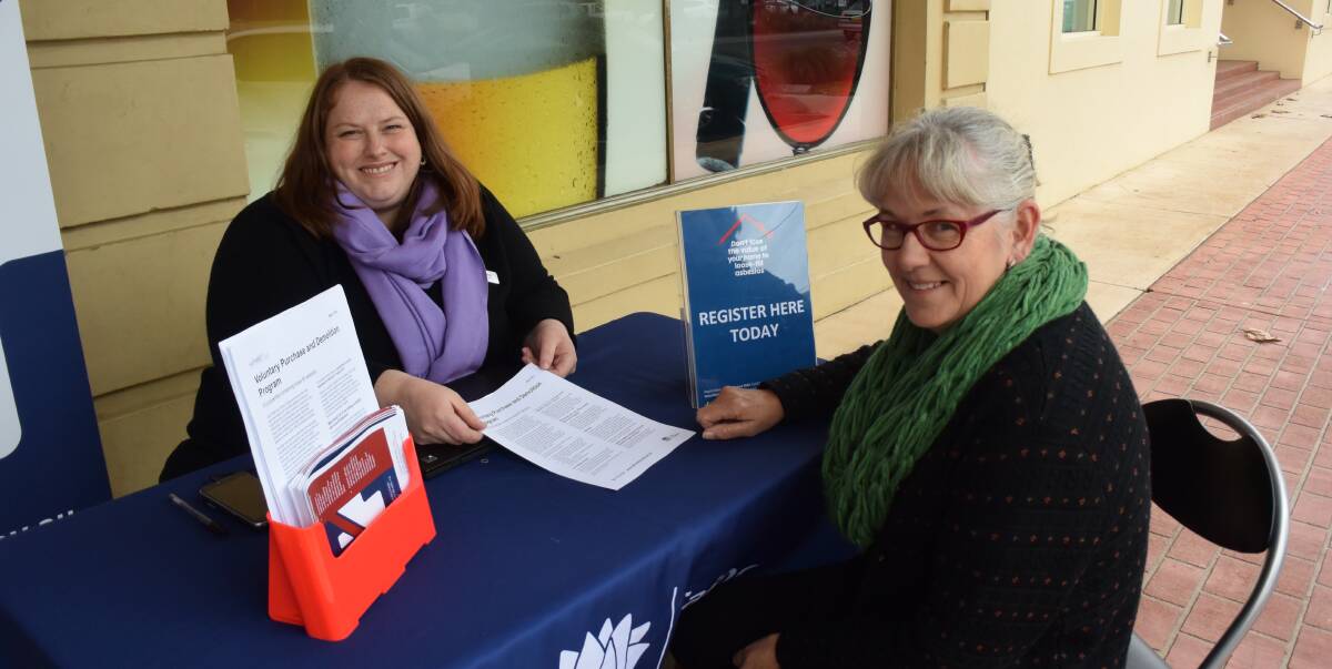 AWARENESS CAMPAIGN: A NSW Fair Trading representative speaks to resident Janelle Quilter at the Culcairn information stand in June. The town has since recorded its first positive result for loose-fill asbestos.