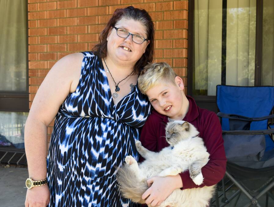 PUPPY GOAL: Belinda Moore and her son Corey, 9, with their cat Charlie. The family is trying to raise $20,000 for an autism assistance dog. Picture: SIMON BAYLISS