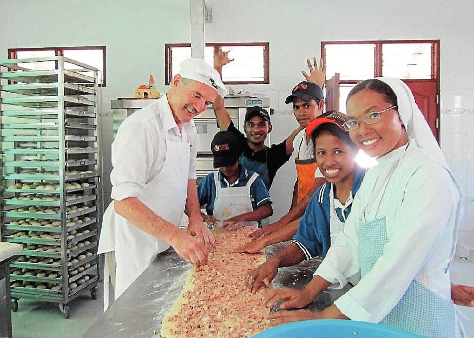 Mr O’Toole gives the East Timorese locals some baking tips.